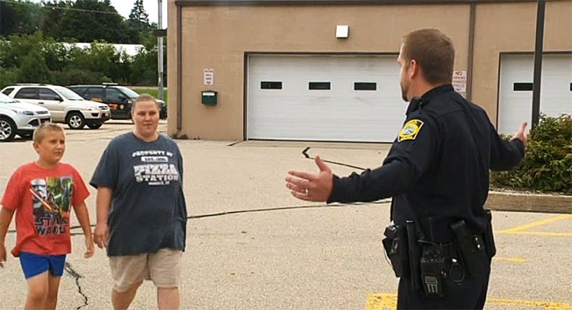Gavin and his mother greet Officer Henning