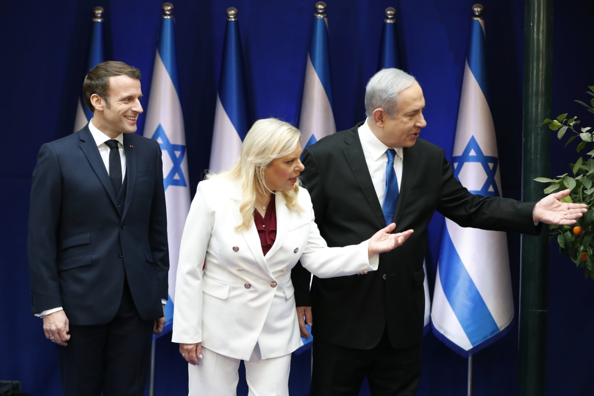 Israeli Prime Minister Benjamin Netanyahu and his wife Sara gesture as they stand next to French President Emmanuel Macron during their meeting in Jerusalem on Jan. 22, 2020. (Ronen Zvulun/Pool Photo via AP)