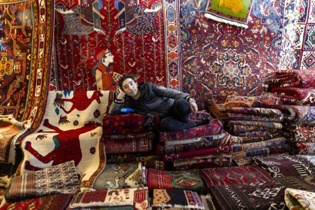A rug vendor poses for a portrait at a weekly Friday market in Tehran, Iran, on Jan. 16, 2026.  (Stringer/Getty Images)