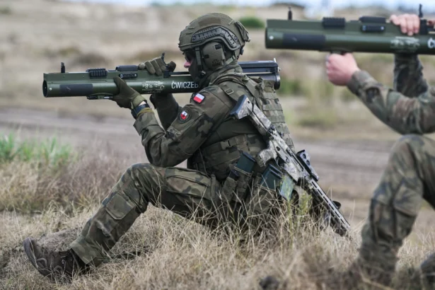 Soldiers of Poland's 3rd Podkarpackie Territorial Defense Brigade prepare a M72 anti-tank grenade launcher during the Iron Defender 25 media day in Nowa Deba, Poland, on Sept. 18, 2025 (Omar Marques/Getty Images)