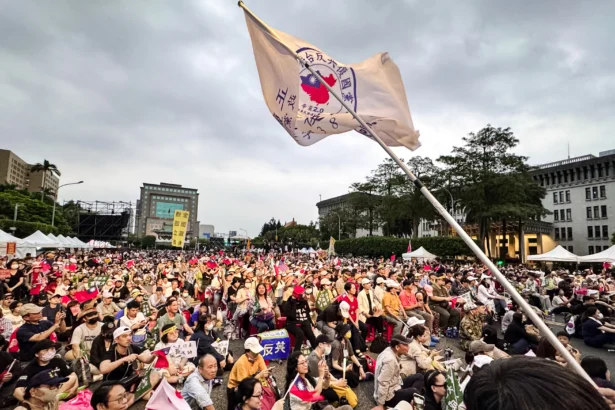 People wave flags and cheer at a 'Reject United Front Work, Protect Taiwan' rally on Kedao Avenue in Taipei, Taiwan, on April 19, 2025. (Sun Xiangyi/The Epoch Times)