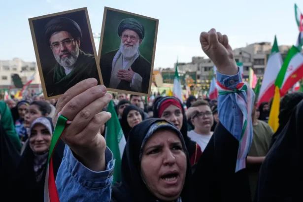 A woman holds up pictures of the Iranian leader Ayatollah Mojtaba Khamenei, left, and his father, the slain Ayatollah Ali Khamenei in a state-organized rally celebrating the birthday of Imam Reza, the 8th Shiite Muslims' imam, and supporting the supreme leader, in Tehran, Iran, on April 29, 2026. (Vahid Salemi/AP Photo)