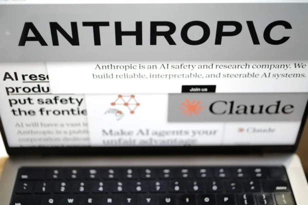Pages from the Anthropic website and the company's logos are displayed on a computer screen in New York on Feb. 26, 2026. (AP Photo/Patrick Sison)