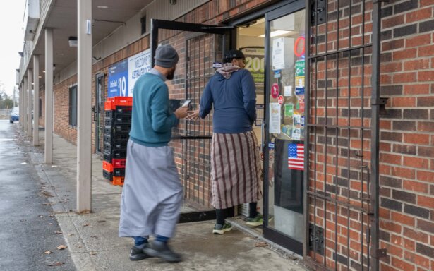 Two shopkeepers walk into their Somali grocery store on Industrial Mile Road in Columbus, Ohio, on Jan. 6, 2026 (Glenn Hartong for The Epoch Times)