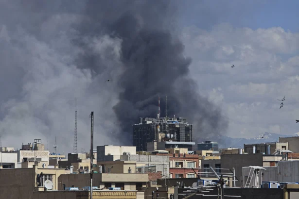 Plumes of smoke rise over the skyline following explosions in Tehran, Iran, on March 1, 2026. (Majid Saeedi/Getty Images)