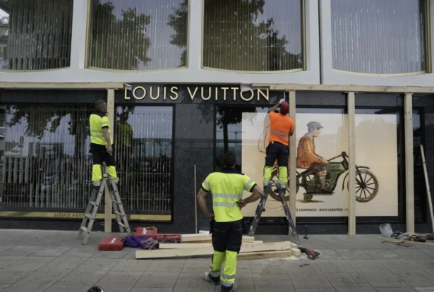Construction workers board up a shop window ahead of expected protests for the G7 summit, in Geneva, Switzerland, on June 8, 2026. (Baz Ratner/AP)
