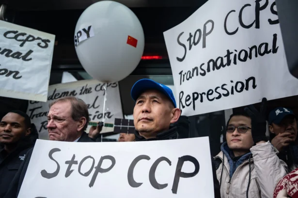 Chinese dissidents rally in front of the America ChangLe Association highlighting Beijing's transnational repression, in New York City on Feb. 25, 2023. A now-closed overseas Chinese police station is located inside the association building. (Samira Bouaou/The Epoch Times)
