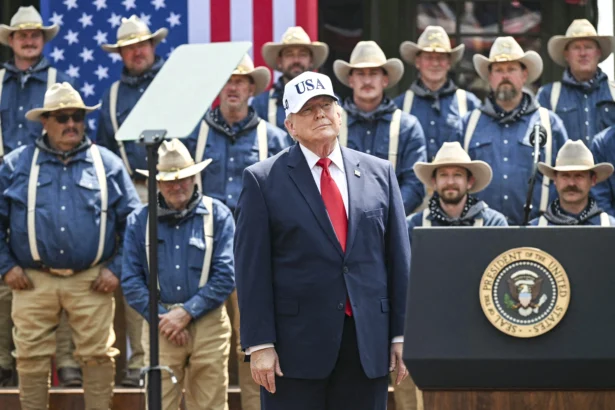 President Donald Trump stands on stage flanked by Rough Riders reenactors, portraying the 1st United States Volunteer Cavalry, at the Burning Hills Amphitheatre after attending the opening of the Theodore Roosevelt Presidential Library in Medora, N.D., on July 1, 2026. (Saul Loeb/AFP via Getty Images)