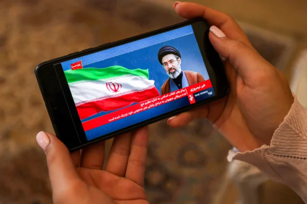 A woman watches a televised broadcast delivered on behalf of Iran's Supreme Leader Mojtaba Khamenei in Tehran on May 26, 2026. (Atta Kenare/AFP via Getty Images)