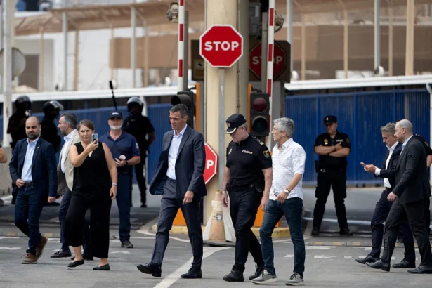 Spain's Prime Minister Pedro Sanchez (C) and Minister of Interior Fernando Grande Marlaska walk by the Tarajal border fence between Spain's north African enclave of Ceuta and Morocco during a visit amid one of the largest migrant crises on the country's border as thousands of migrants crossed overnight from Morocco on July 31, 2026. (Jorge Guerrero/AFP via Getty Images)