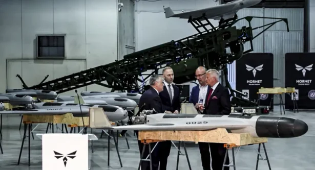 Polish Deputy Defense Minister Cezary Tomczyk (2nd L) visits a Hornet drone plant in Sochaczew, Poland, on July 9, 2026. (Reuters)